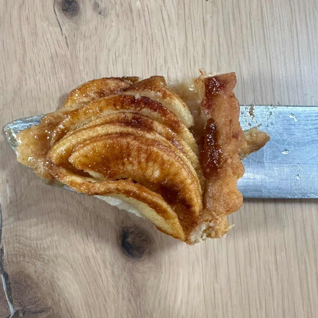 Apple Sourdough Tart – SEBAlicious™ Artisan Dessert (Des Plaines, IL) - Artisan Real Sourdough Bread Chef SebaArtisan Real Sourdough Bread Chef SebaArtisan Real Sourdough Bread Chef SebaSEBA-DS-ASTClose - up bite of artisan apple tart with caramelized apple slices and flaky buttery crust by Chef SEBA