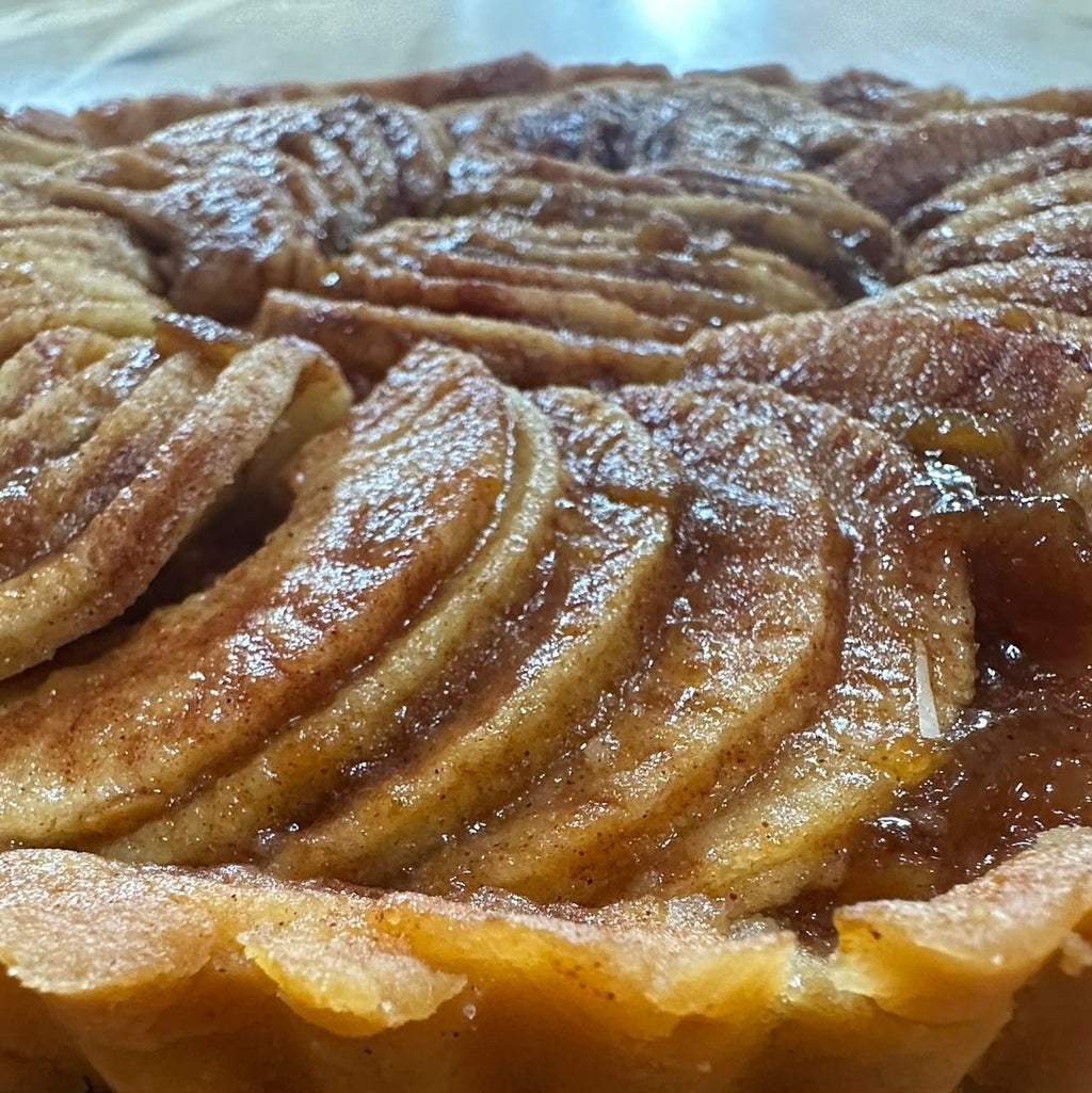 Apple Sourdough Tart – SEBAlicious™ Artisan Dessert (Des Plaines, IL) - Artisan Real Sourdough Bread Chef SebaArtisan Real Sourdough Bread Chef SebaArtisan Real Sourdough Bread Chef SebaSEBA-DS-ASTClose - up of artisan apple tart with thinly sliced caramelized apples and flaky golden crust by Chef SEBA