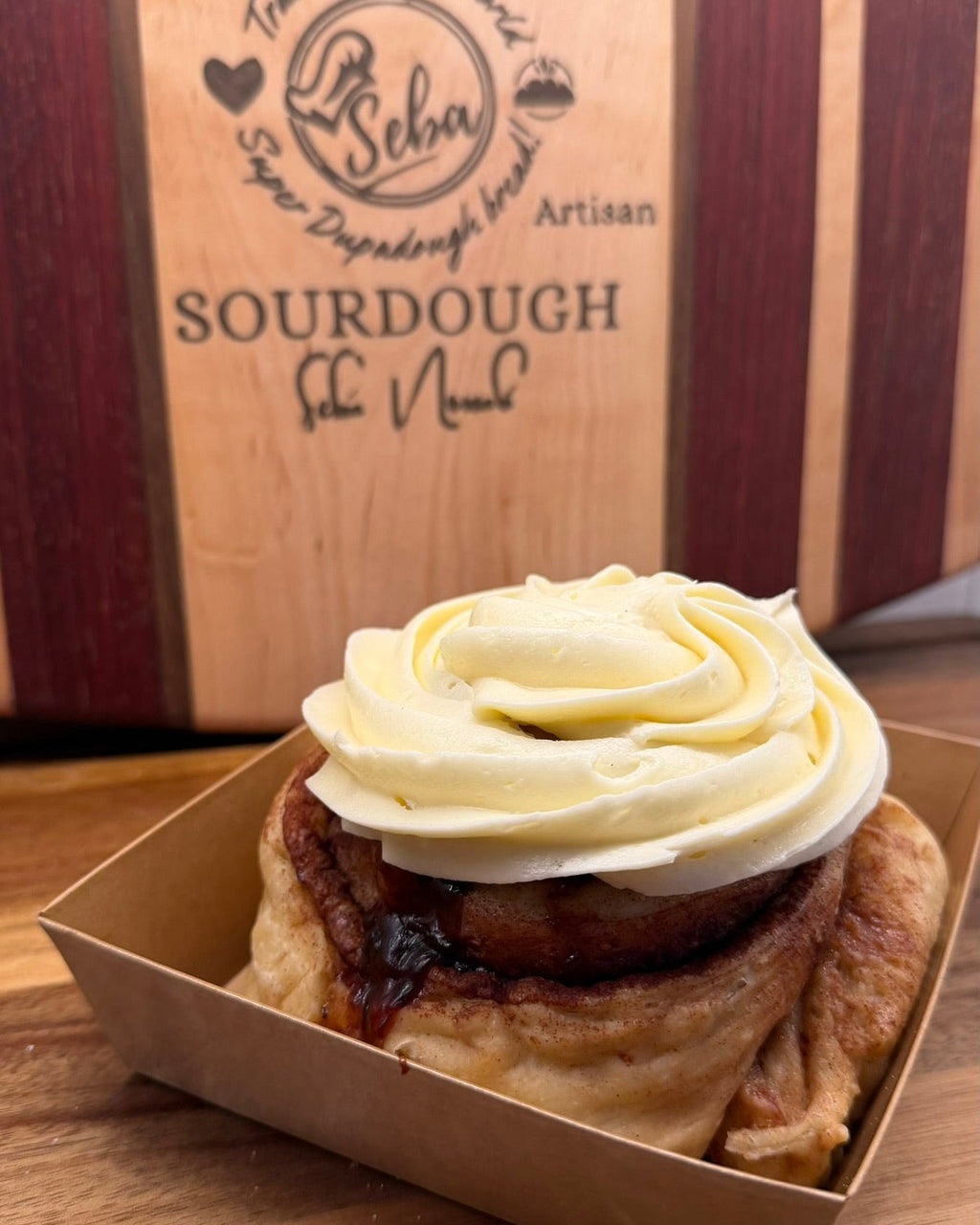 Cinnamon Sourdough Rolls | Artisan Sweet Rolls by Chef SEBA - Artisan Real Sourdough Bread Chef SebaArtisan Real Sourdough Bread Chef SebaArtisan Real Sourdough Bread Chef SebaSEBA-CIN-ROLL-1SEBA-CIN-ROLLsingleSide view artisan sourdough cinnamon roll with thick cream cheese frosting by Chef SEBA bakery