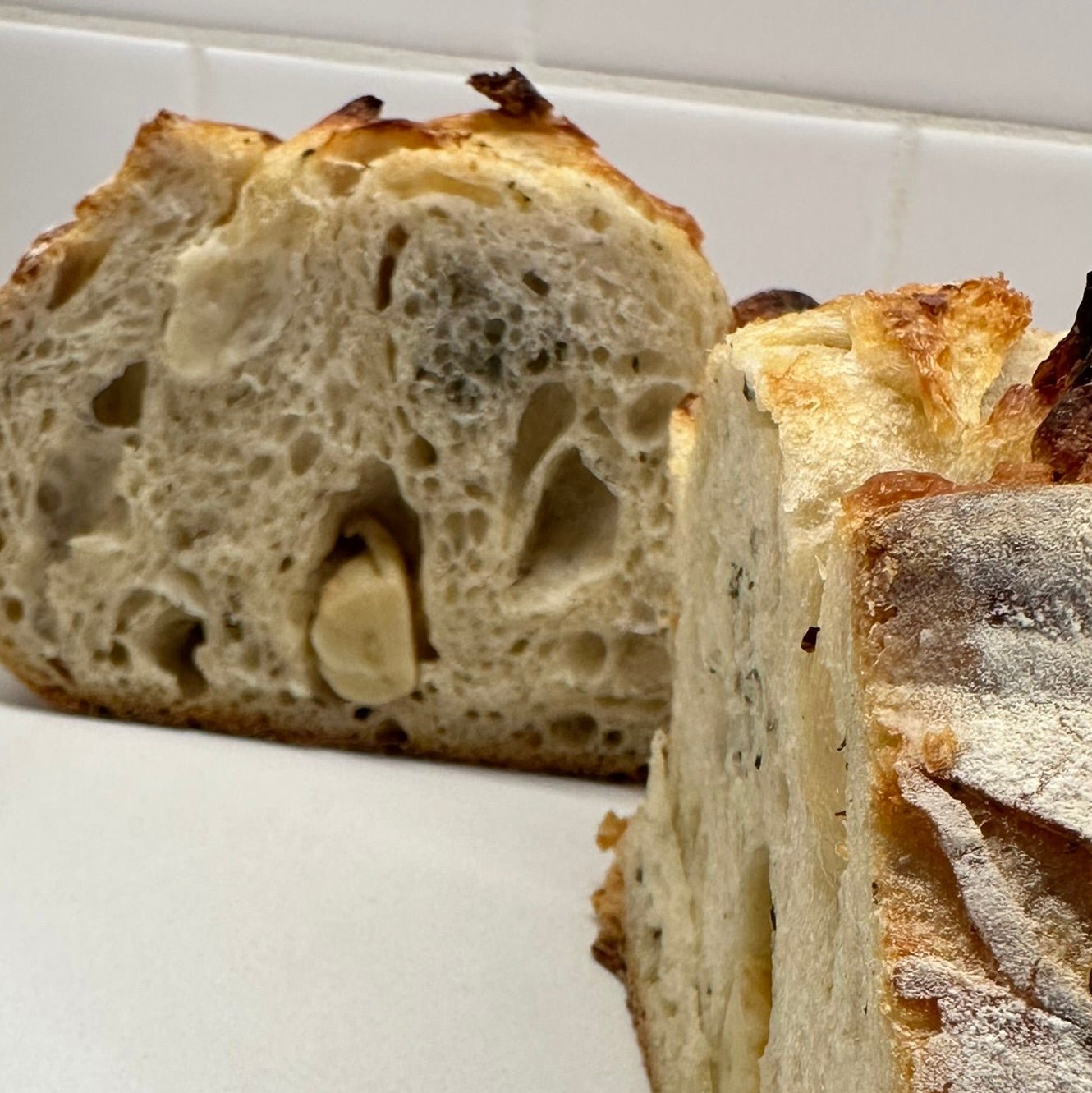 Garlic Rosemary Sourdough Bread – Chef SEBA Artisan Loaf (Savory, Naturally Fermented) - Artisan Real Sourdough Bread Chef SebaArtisan Real Sourdough Bread Chef SebaArtisan Real Sourdough Bread Chef SebaSEBA-FB-GRWhole Loafinside crumb of garlic rosemary sourdough bread showing soft airy texture and open crumb