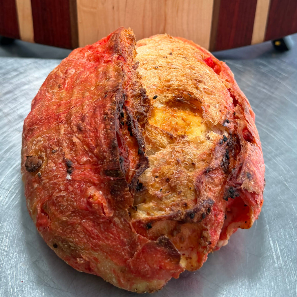 Gourmet artisan sourdough bread with Flamin Hot Cheetos and cheddar cheese