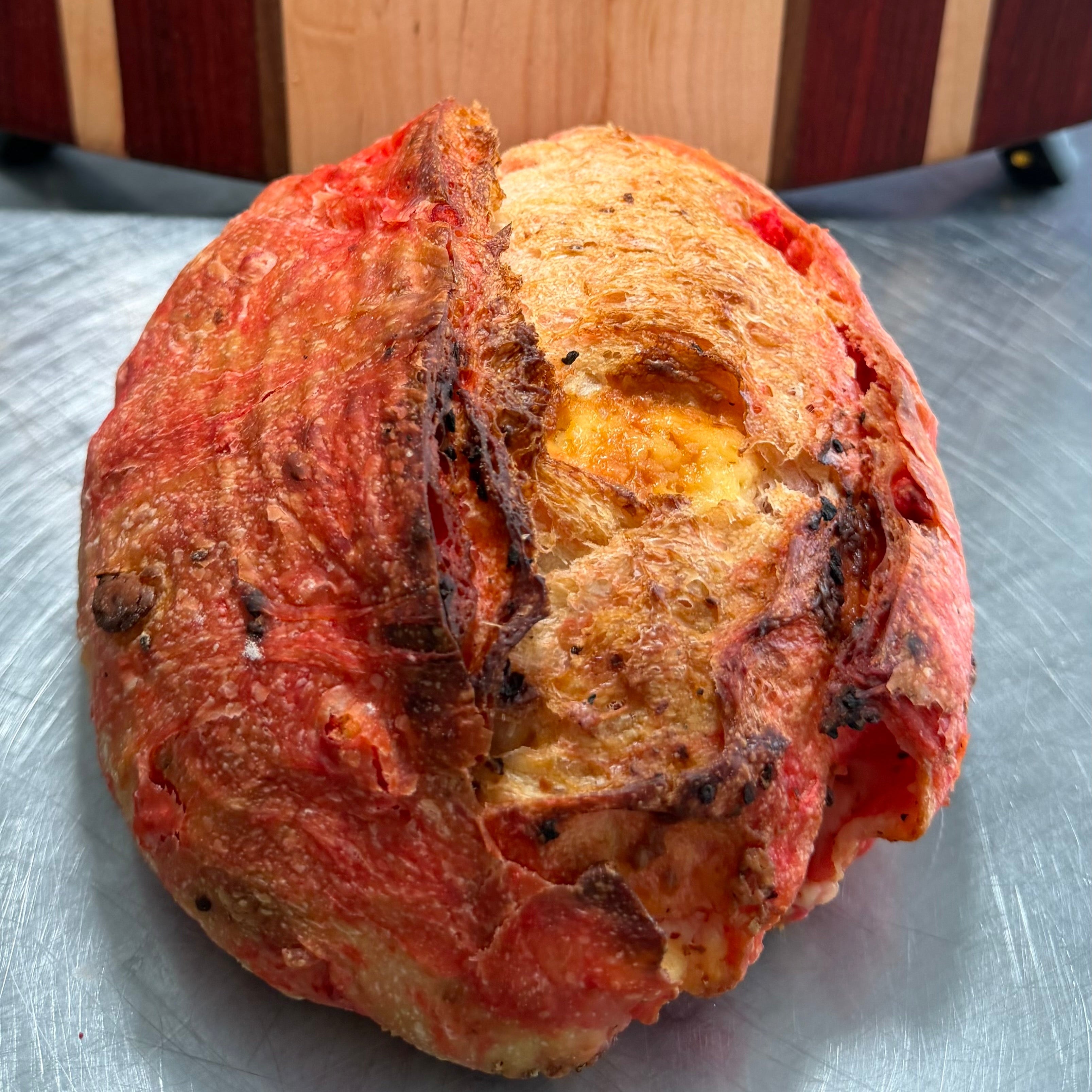 Gourmet artisan sourdough bread with Flamin Hot Cheetos and cheddar cheese