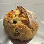 Green Olive Artisan Sourdough Bread – Chef SEBA Organic Vegan Loaf (Mediterranean Style, Naturally Fermented) - Artisan Real Sourdough Bread Chef SebaArtisan Real Sourdough Bread Chef SebaArtisan Real Sourdough Bread Chef SebaSEBA-BRD-OLV-WHLMED-ROLL-01Whole LoafWhole green olive sourdough loaf with crispy crust artisan bread Chef SEBA