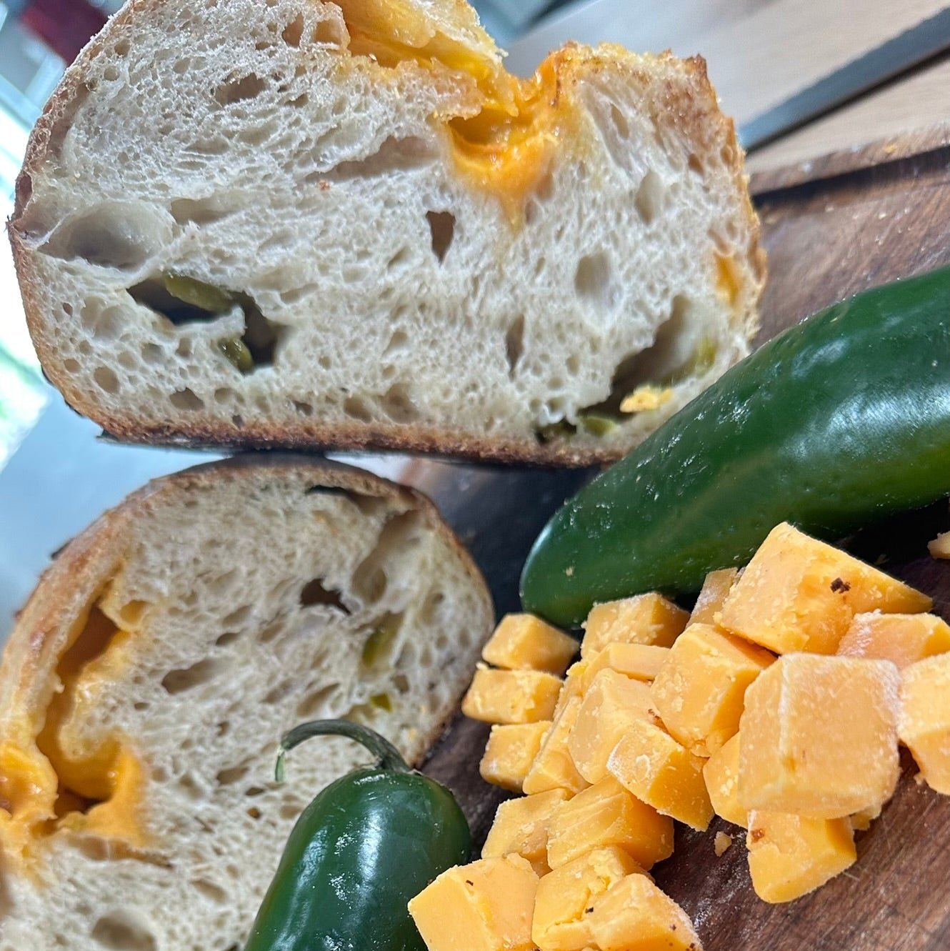 Jalapeño Cheddar Sourdough Bread – Chef SEBA Artisan Loaf - Artisan Real Sourdough Bread Chef SebaArtisan Real Sourdough Bread Chef SebaArtisan Real Sourdough Bread Chef SebaSEBA-BRD-JAL-CHD-WHLJAL-CHED-01Whole LoafSliced jalapeño cheddar sourdough bread showing cheese pockets and soft crumb