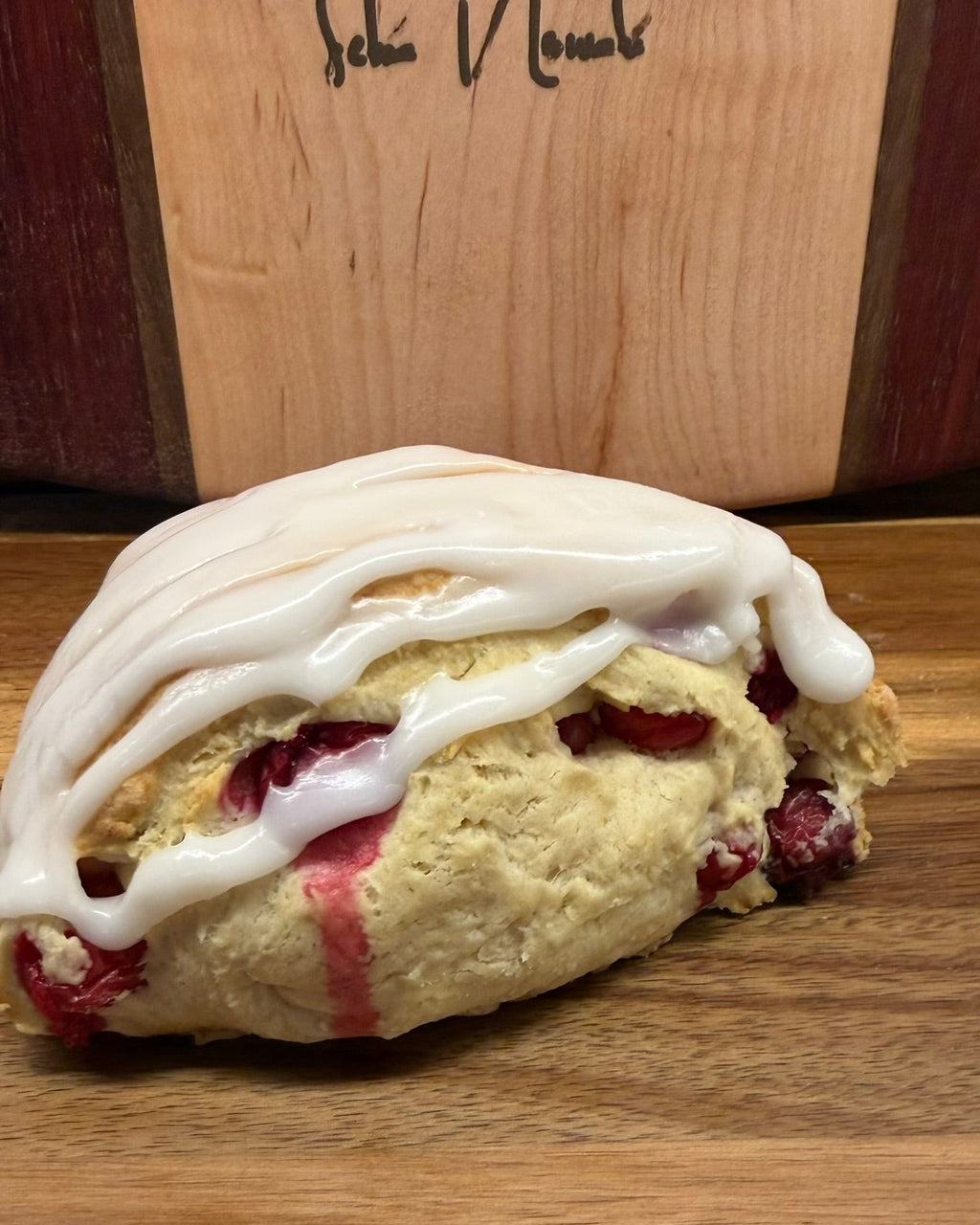 Organic Cranberry Lemon Sourdough Scones – Chef SEBA Artisan Bakery - Artisan Real Sourdough Bread Chef SebaArtisan Real Sourdough Bread Chef SebaArtisan Real Sourdough Bread Chef SebaSEBA-SCON-CRAN-LEM-0011singleClose - up of cranberry lemon sourdough scone showing soft crumb and fruit filling with glaze by Chef SEBA