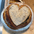 Top view of Polski Chleb Weselny artisan sourdough decorated with a large heart