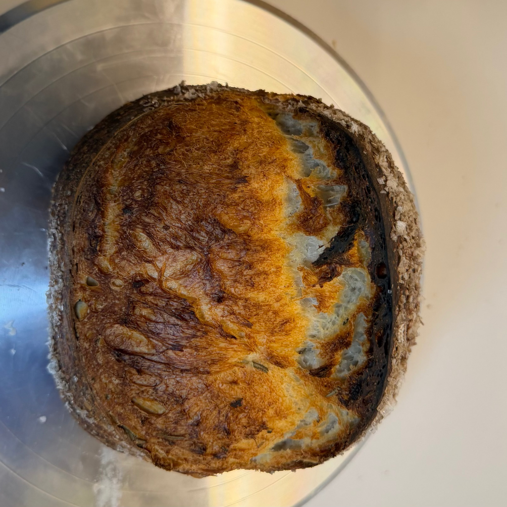 Sliced organic rosemary sea salt sourdough bread showing soft airy crumb and crispy crust