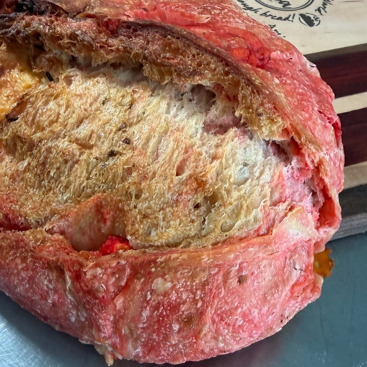 SEBAlicious™ Flamin’ Hot Cheetos Extra Sharp Cheddar Sourdough Bread - Artisan Real Sourdough Bread Chef SebaArtisan Real Sourdough Bread Chef SebaArtisan Real Sourdough Bread Chef SebaWhole LoafExtra sharp cheddar and Flamin Hot Cheetos sourdough bread close-up