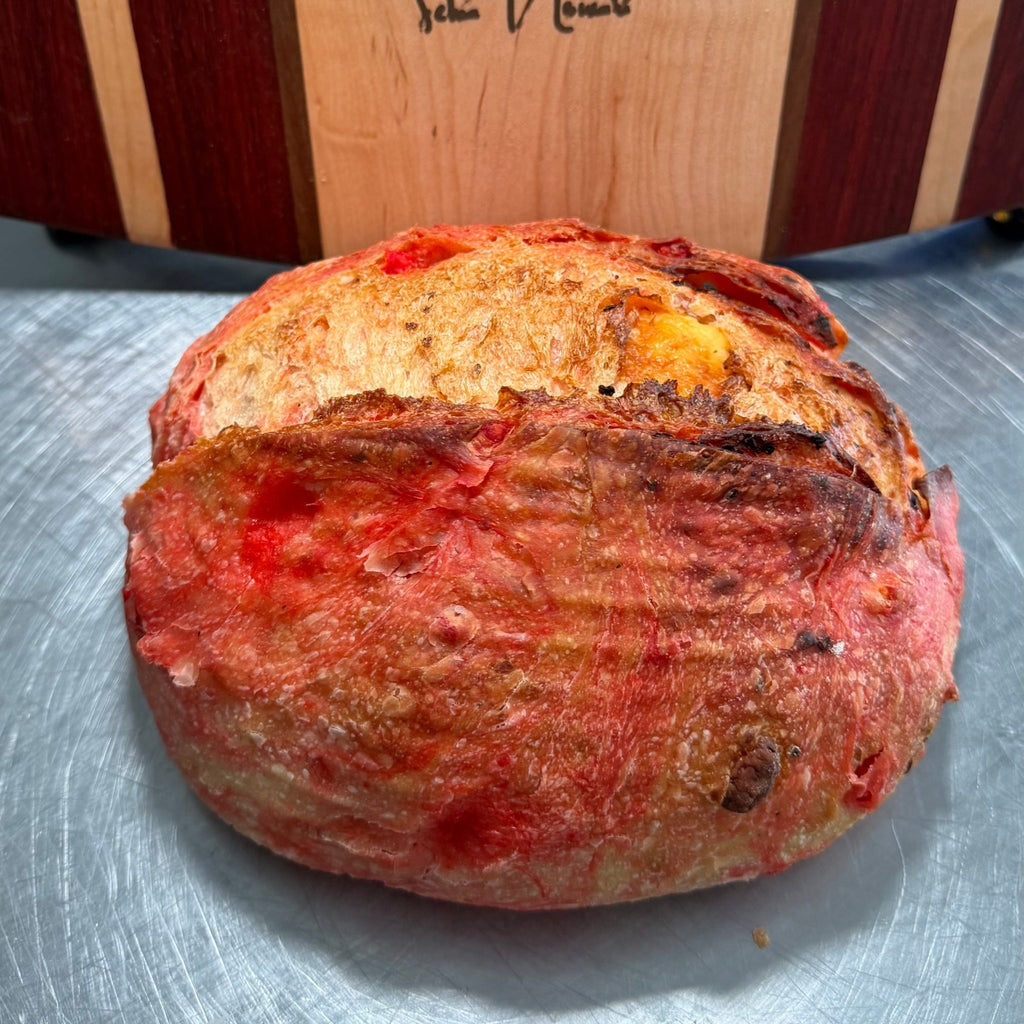 SEBAlicious™ Flamin’ Hot Cheetos Extra Sharp Cheddar Sourdough Bread - Artisan Real Sourdough Bread Chef SebaArtisan Real Sourdough Bread Chef SebaArtisan Real Sourdough Bread Chef SebaWhole LoafWhole Flamin Hot Cheetos artisan sourdough loaf with crispy crust