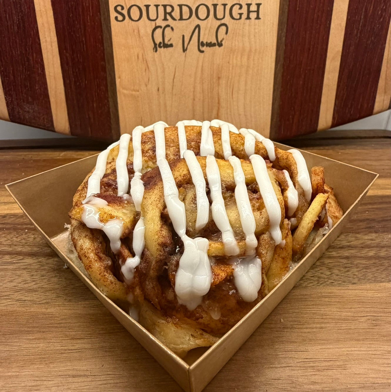 Close up sourdough apple roll with cinnamon apples and lemon icing drizzle by Chef SEBA in Des Plaines Illinois