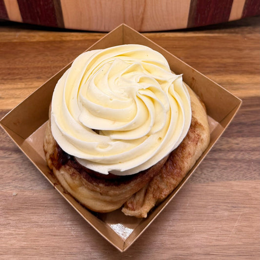 Artisan sourdough cinnamon roll topped with rich cream cheese frosting by Chef SEBA bakery in Des Plaines Illinois